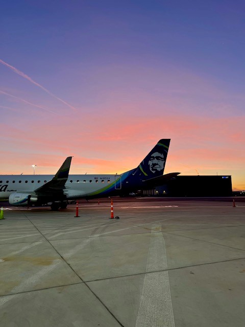 Alaska Airlines plane parked on the SBP airport ramp at sunrise