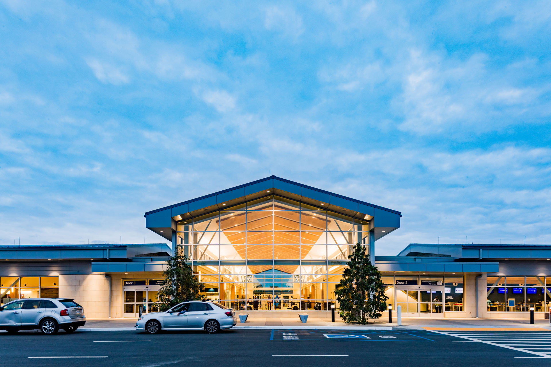 The front of the SLO Airport Terminal shining bright at dusk