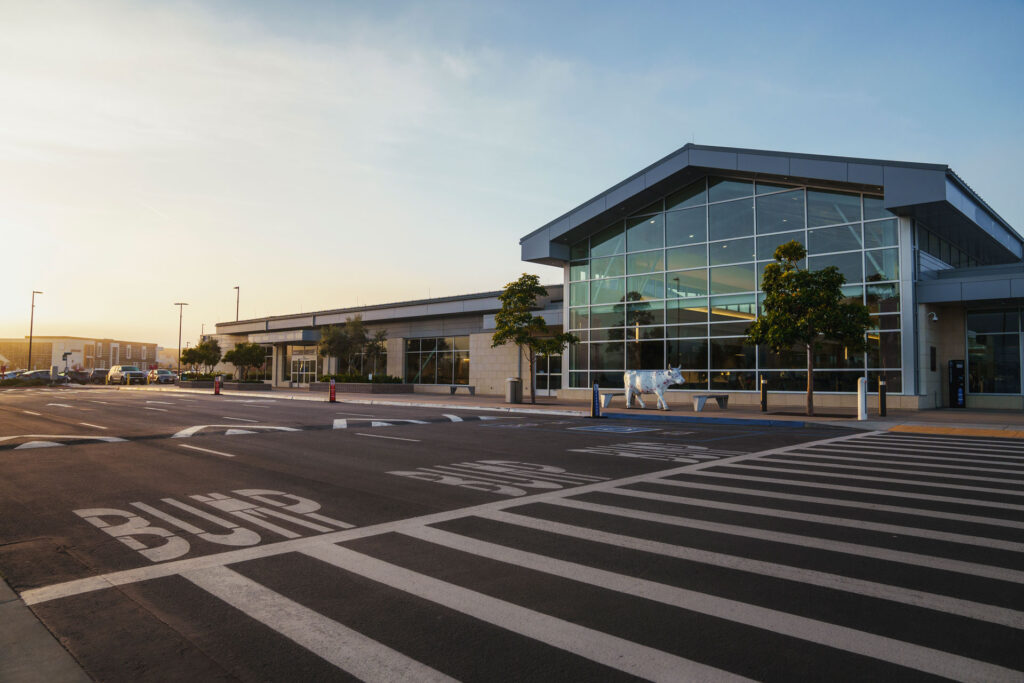 An outside view from the passenger drop off curb of the San Luis Obispo Airport terminal building at sunset.